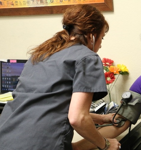nurse checks blood pressure