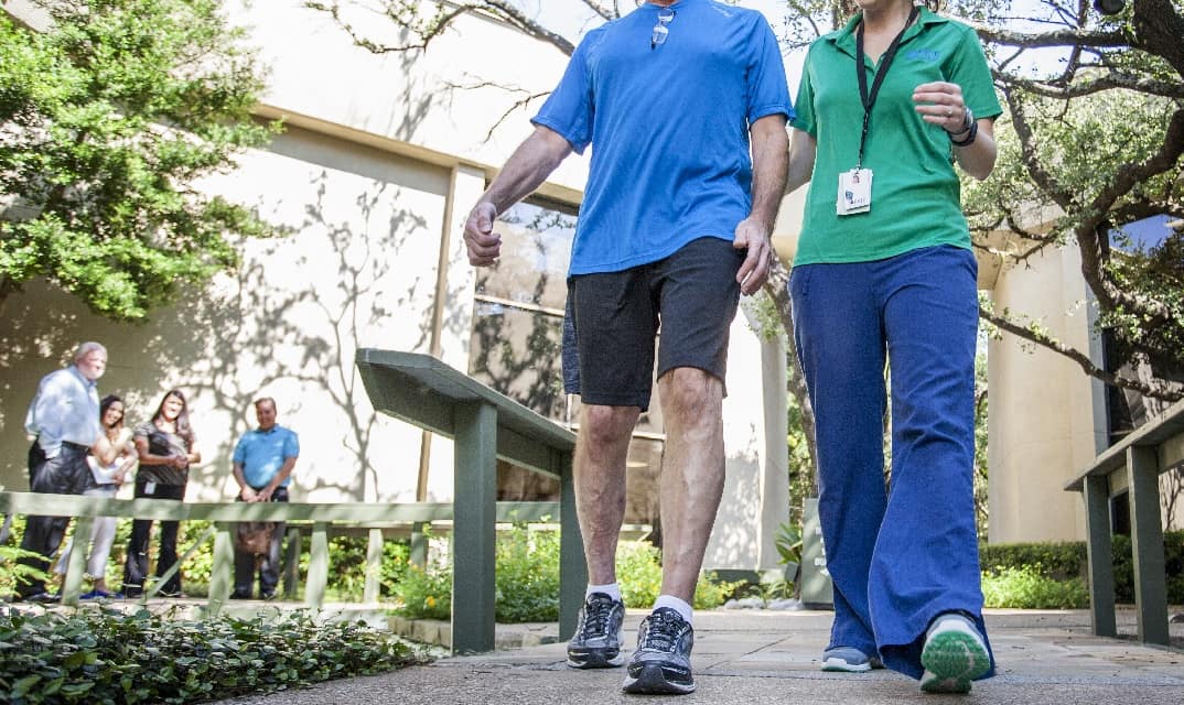 stroke brain injury patient walking with a therapist